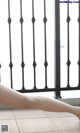 A woman's legs are shown in front of a railing.